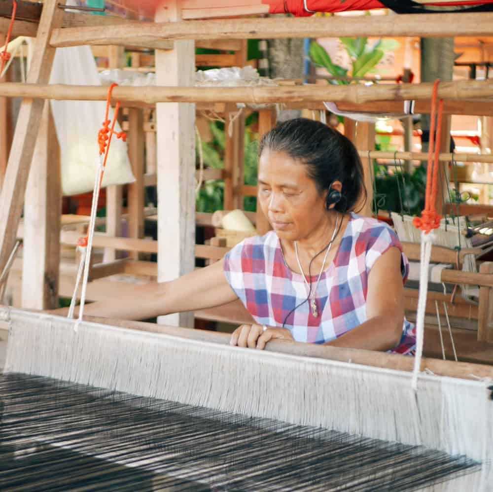 Woman working on a weaving loom